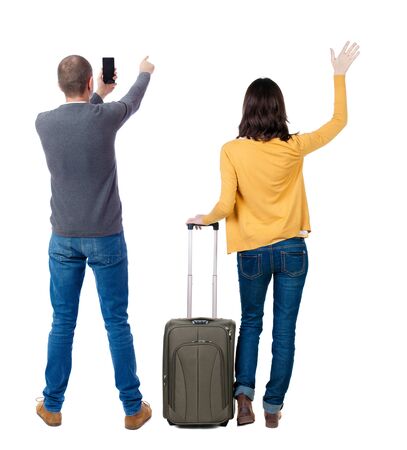 Back view of couple in sweater with mobile phone. beautiful friendly girl and guy together. Rear view people collection. backside view of person. Isolated over white background.の写真素材