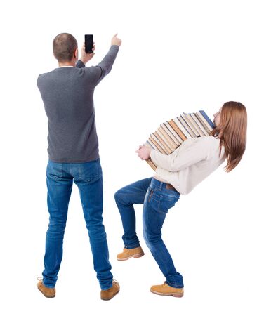 Back view of couple in sweater with mobile phone. beautiful friendly girl and guy together. Rear view people collection. backside view of person. Isolated over white background.の写真素材