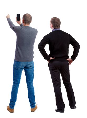 Back view of two man in sweater with mobile phone. Rear view people collection. backside view of person. Isolated over white background.の写真素材