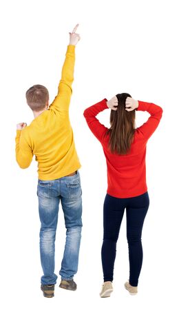 Back view of couple in sweater pointing. Rear view people collection. backside view of person. Isolated over white background.の写真素材