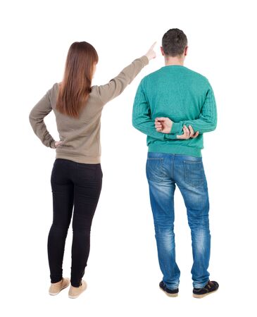 Back view of couple in sweater with mobile phone. beautiful friendly girl and guy together. Rear view people collection. backside view of person. Isolated over white background.の写真素材