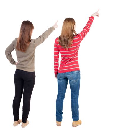 Back view of two young woman photographed on a mobile phone in sweater. Rear view people collection. backside view of person. Rear view. Isolated over white background.の写真素材