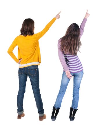 Back view of two young woman photographed on a mobile phone in sweater. Rear view people collection. backside view of person. Rear view. Isolated over white background.の写真素材