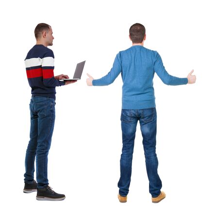 Back view two man in sweater with laptop. Rear view people collection. backside view of person. Isolated over white background. Guys looking forwardの写真素材