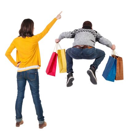 back view of couple with shopping bags. backside view of person. Rear view people collection. Isolated over white background.の写真素材