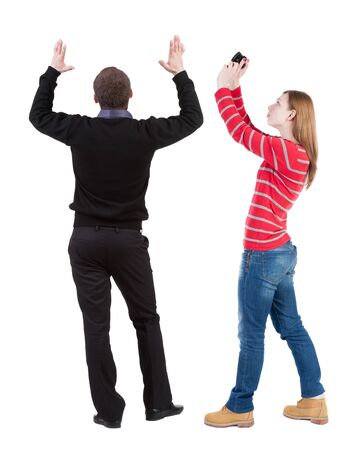 Back view of couple in sweater with mobile phone. beautiful friendly girl and guy together. Rear view people collection. backside view of person. Isolated over white background.の写真素材