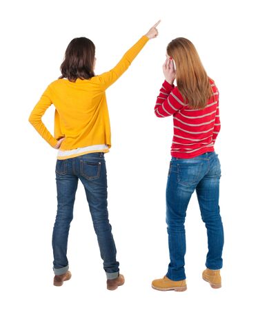 Back view of two young woman photographed on a mobile phone in sweater. Rear view people collection. backside view of person. Rear view. Isolated over white background.の写真素材