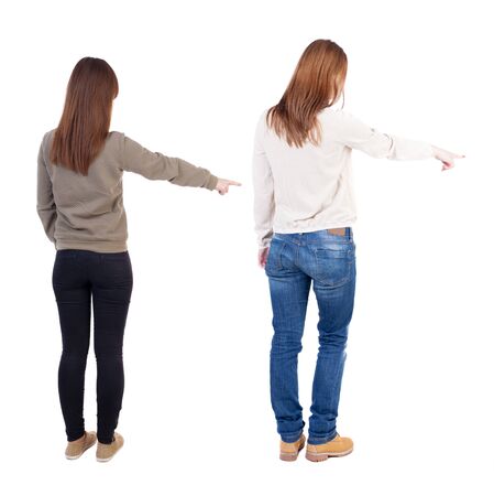 Back view of two young woman photographed on a mobile phone in sweater. Rear view people collection. backside view of person. Rear view. Isolated over white background.の写真素材