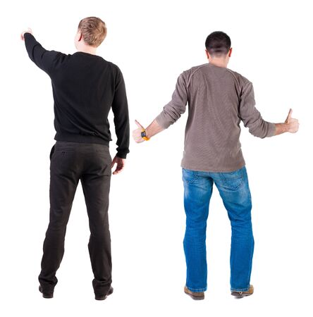 Back view of two man in sweater pointing. Rear view people collection. backside view of person. Isolated over white background.の写真素材