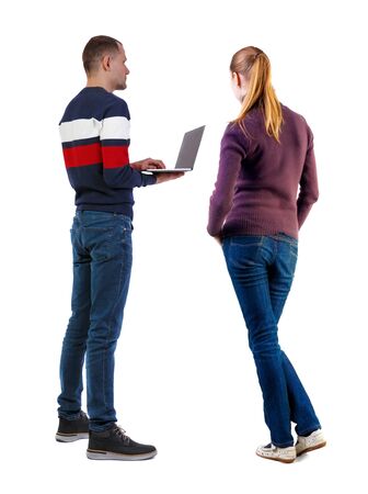 Back view couple with laptop in sweater. beautiful man and woman. Rear view people collection. backside view of person. Isolated over white background.の写真素材