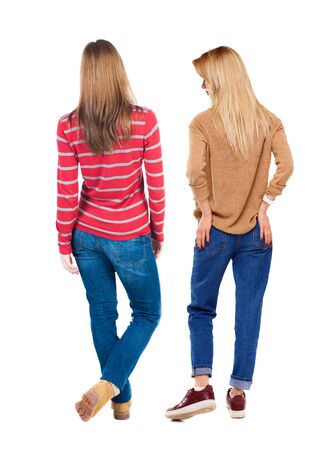 Back view of two woman in sweater. Rear view people collection. backside view of person. Isolated over white background.の写真素材