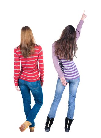 Back view of two young woman photographed on a mobile phone in sweater. Rear view people collection. backside view of person. Rear view. Isolated over white background.の写真素材