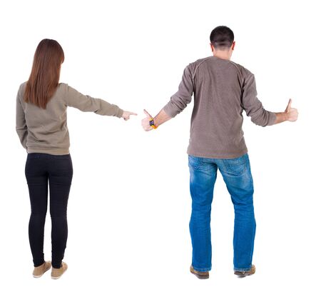 Back view of couple in sweater with mobile phone. beautiful friendly girl and guy together. Rear view people collection. backside view of person. Isolated over white background.の写真素材