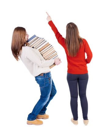 Back view of two young woman photographed on a mobile phone in sweater. Rear view people collection. backside view of person. Rear view. Isolated over white background.の写真素材