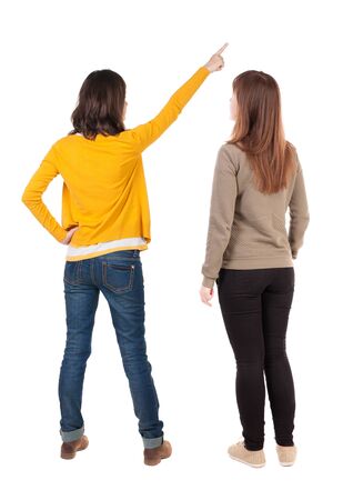 Back view of two young woman photographed on a mobile phone in sweater. Rear view people collection. backside view of person. Rear view. Isolated over white background.の写真素材