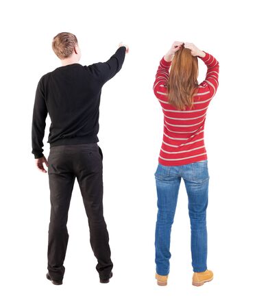 Back view of couple in sweater with mobile phone. beautiful friendly girl and guy together. Rear view people collection. backside view of person. Isolated over white background.の写真素材