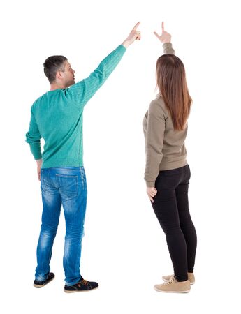 Back view of couple in sweater with mobile phone. beautiful friendly girl and guy together. Rear view people collection. backside view of person. Isolated over white background.の写真素材