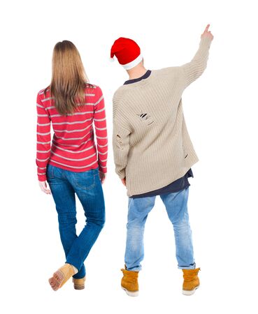 Back view of couple in sweater with mobile phone. beautiful friendly girl and guy together. Rear view people collection. backside view of person. Isolated over white background.の写真素材