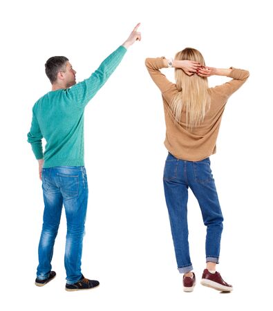 Back view of couple in sweater with mobile phone. beautiful friendly girl and guy together. Rear view people collection. backside view of person. Isolated over white background.の写真素材