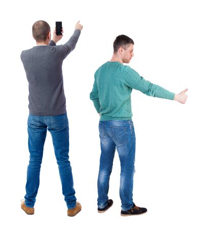 Back view of two man in sweater with mobile phone. Rear view people collection. backside view of person. Isolated over white background.の写真素材