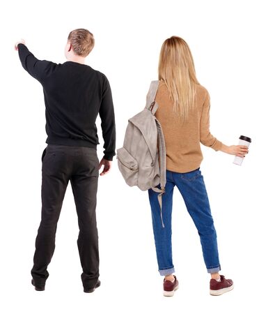 Back view of couple in sweater with mobile phone. beautiful friendly girl and guy together. Rear view people collection. backside view of person. Isolated over white background.の写真素材