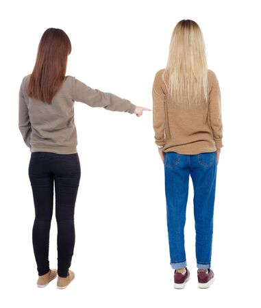 Back view of two young woman photographed on a mobile phone in sweater. Rear view people collection. backside view of person. Rear view. Isolated over white background.の写真素材