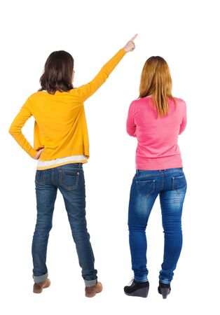 Back view of two young woman photographed on a mobile phone in sweater. Rear view people collection. backside view of person. Rear view. Isolated over white background.の写真素材