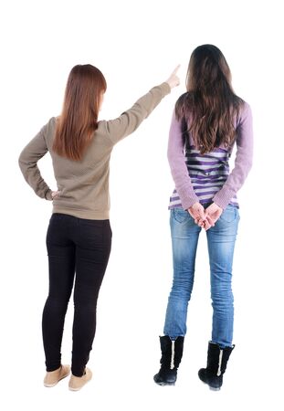 Back view of two young woman photographed on a mobile phone in sweater. Rear view people collection. backside view of person. Rear view. Isolated over white background.の写真素材