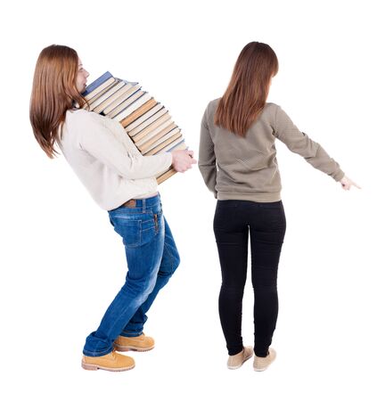 Back view of two young woman photographed on a mobile phone in sweater. Rear view people collection. backside view of person. Rear view. Isolated over white background.の写真素材
