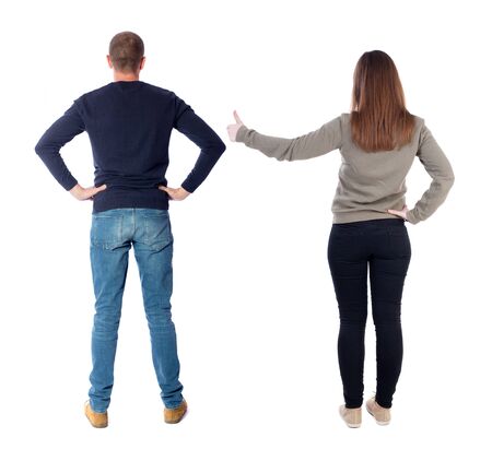 Back view of couple in sweater showing thumbs up. beautiful woman and man together. Rear view people collection. backside view of person. Isolated over white background.の写真素材