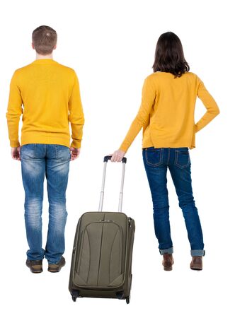 young couple in sweater traveling with suitcas. Back view. Rear view people collection. backside view of person. Isolated over white background.の写真素材