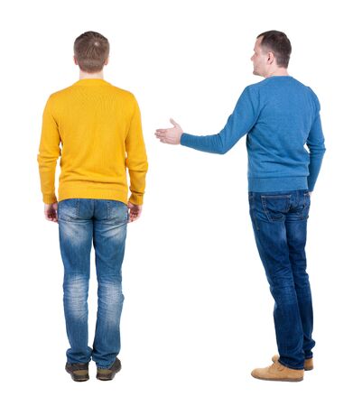 Back view of two man in sweater pointing. Rear view people collection. backside view of person. Isolated over white background.の写真素材