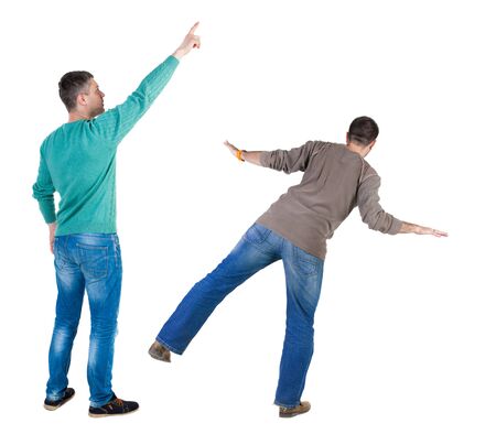 Back view of two man in sweater pointing. Rear view people collection. backside view of person. Isolated over white background.の写真素材