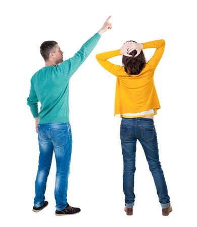 Back view of couple in sweater with mobile phone. beautiful friendly girl and guy together. Rear view people collection. backside view of person. Isolated over white background.の写真素材