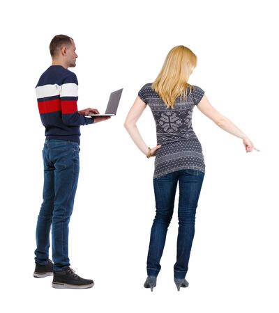 Back view couple with laptop in sweater. beautiful man and woman. Rear view people collection. backside view of person. Isolated over white background.の写真素材
