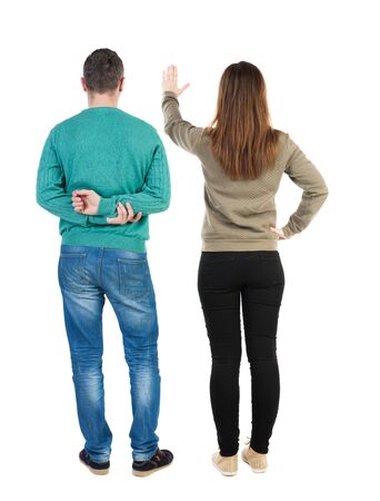 Back view of couple in sweater with mobile phone. beautiful friendly girl and guy together. Rear view people collection. backside view of person. Isolated over white background.の写真素材