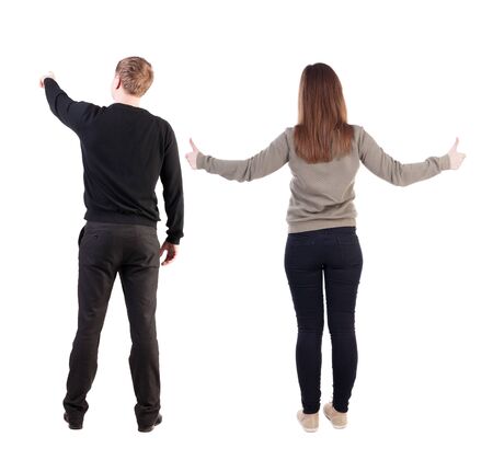Back view of couple in sweater with mobile phone. beautiful friendly girl and guy together. Rear view people collection. backside view of person. Isolated over white background.の写真素材