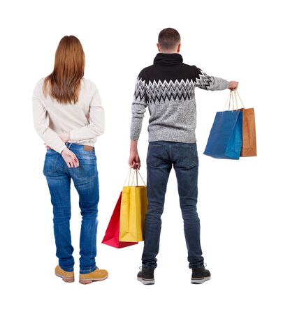 back view of couple with shopping bags. backside view of person. Rear view people collection. Isolated over white background.の写真素材