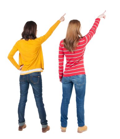 Back view of two young woman photographed on a mobile phone in sweater. Rear view people collection. backside view of person. Rear view. Isolated over white background.の写真素材