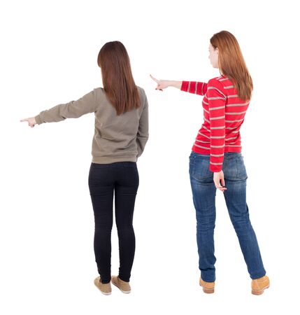 Back view of two young woman photographed on a mobile phone in sweater. Rear view people collection. backside view of person. Rear view. Isolated over white background.の写真素材