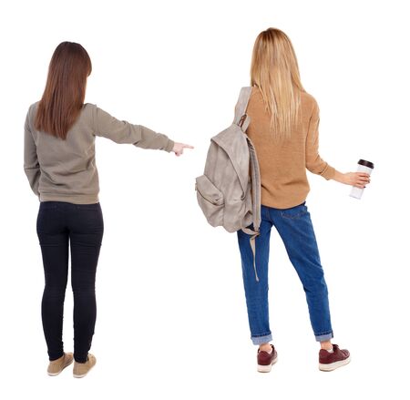 Back view of two young woman photographed on a mobile phone in sweater. Rear view people collection. backside view of person. Rear view. Isolated over white background.の写真素材