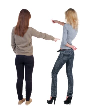 Back view of two young woman photographed on a mobile phone in sweater. Rear view people collection. backside view of person. Rear view. Isolated over white background.の写真素材