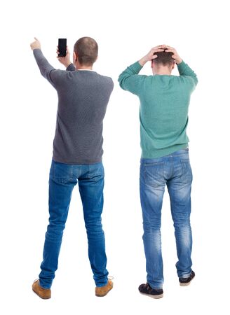 Back view of two man in sweater with mobile phone. Rear view people collection. backside view of person. Isolated over white background.の写真素材