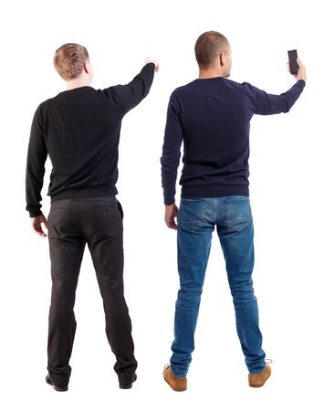 Back view of two man in sweater with mobile phone. Rear view people collection. backside view of person. Isolated over white background.の写真素材