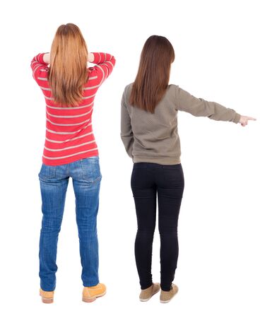 Back view of two young woman photographed on a mobile phone in sweater. Rear view people collection. backside view of person. Rear view. Isolated over white background.の写真素材