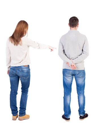 Back view of couple in sweater pointing. Rear view people collection. backside view of person. Isolated over white background.の写真素材