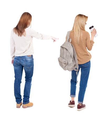 Back view of two pointing girl in sweater. Rear view people collection. backside view of person. beautiful woman showing gesture. Rear view. Isolated over white background.の写真素材