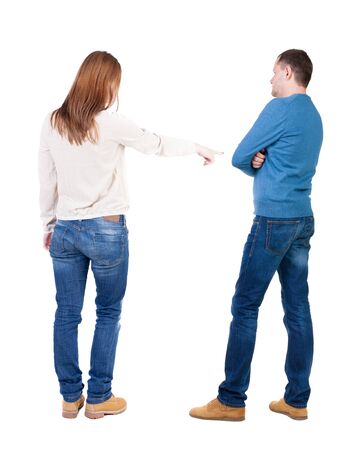 Back view of couple in sweater pointing. Rear view people collection. backside view of person. Isolated over white background.の写真素材