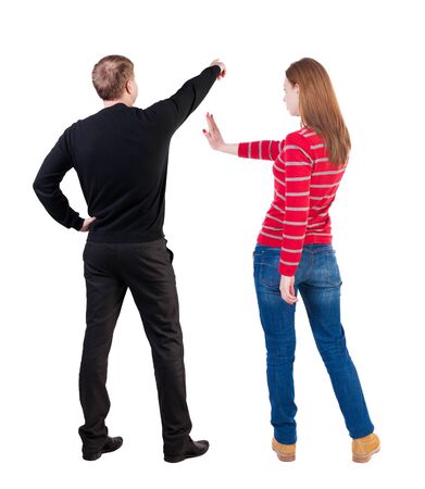Back view of couple in sweater pointing. Rear view people collection. backside view of person. Isolated over white background.の写真素材