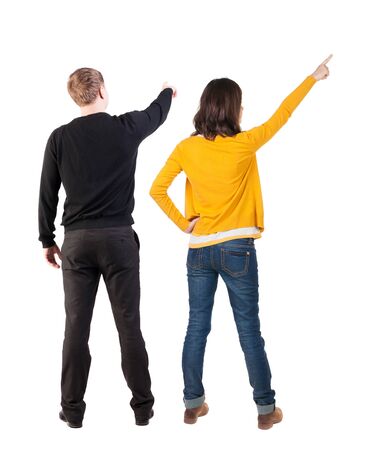 Back view of couple in sweater pointing. Rear view people collection. backside view of person. Isolated over white background.の写真素材